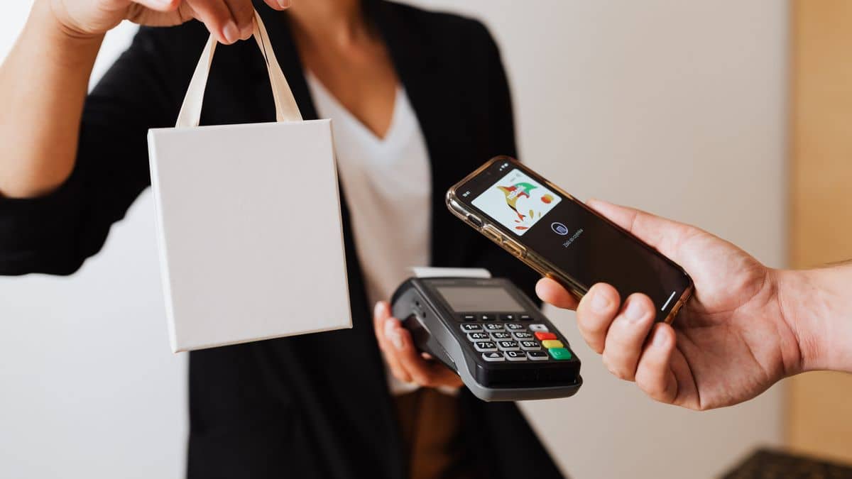Person paying with mobile money on a smartphone to buy a domain in Tanzania