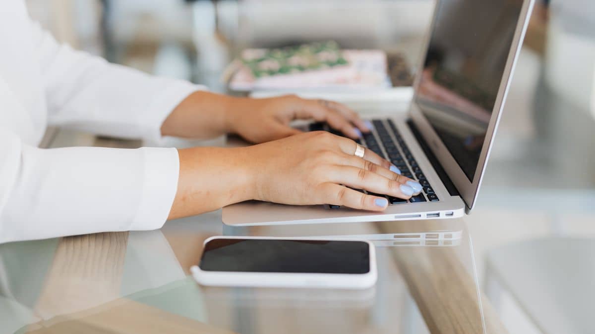 Person typing on a laptop setting up professional email on their domain